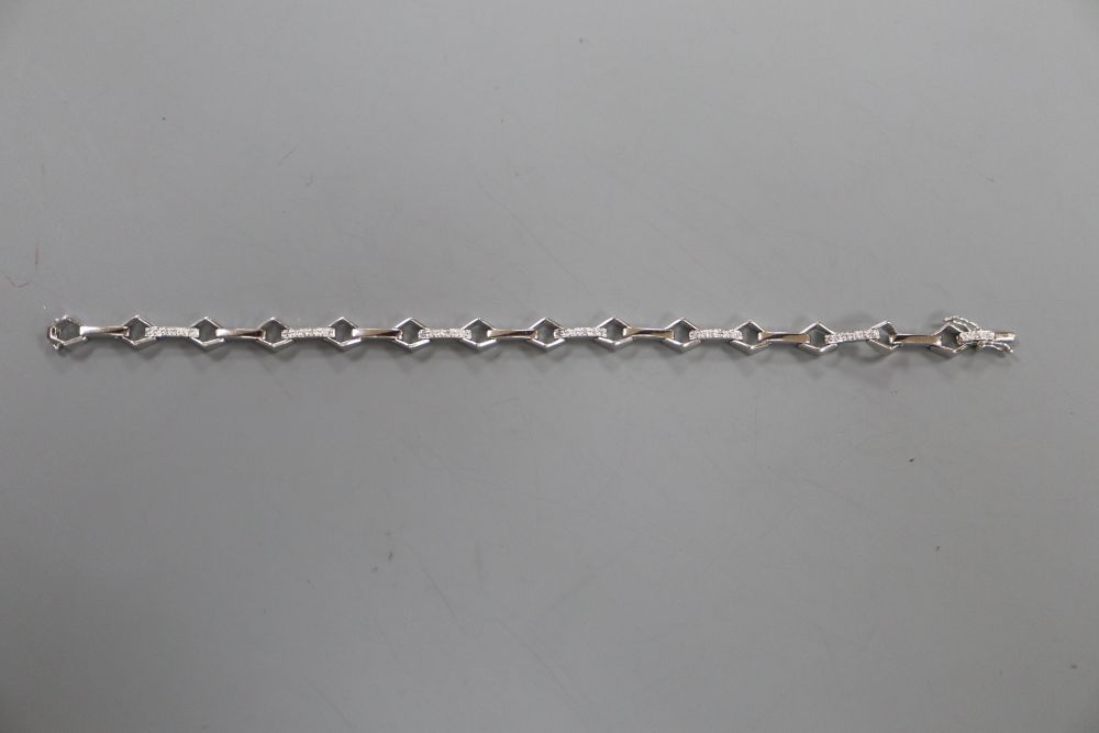 A modern 18k and diamond chip set baton and diamond shaped link line bracelet, 17.5cm, gross 9.5 grams.